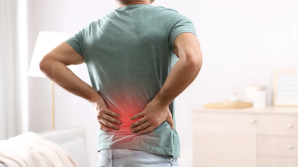 man standing with lower back pain